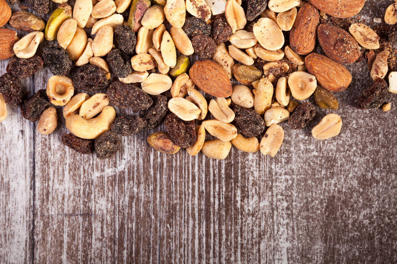 Top down view of trail mix on wooden table