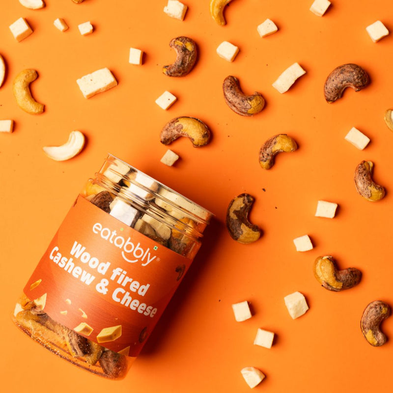 Eatabbly cashews and cheese on orange background