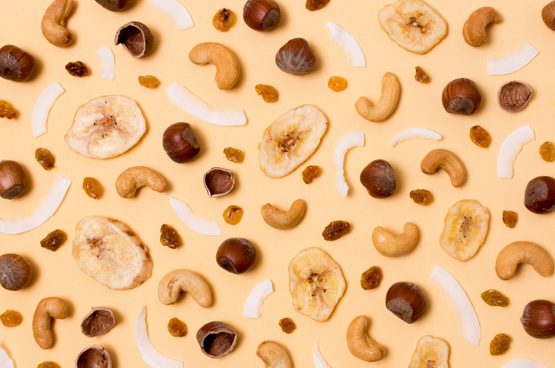Cashew, Hazelnuts and dried fruits on yellow background