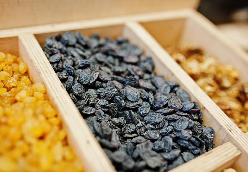3 different tyoes of raisins in trays