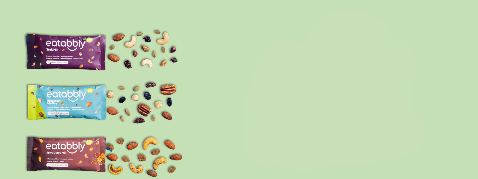 Three eatabbly protein bars with various nuts and seeds on a light green background